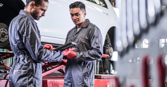 man in workshop infront of a car with brake booster 