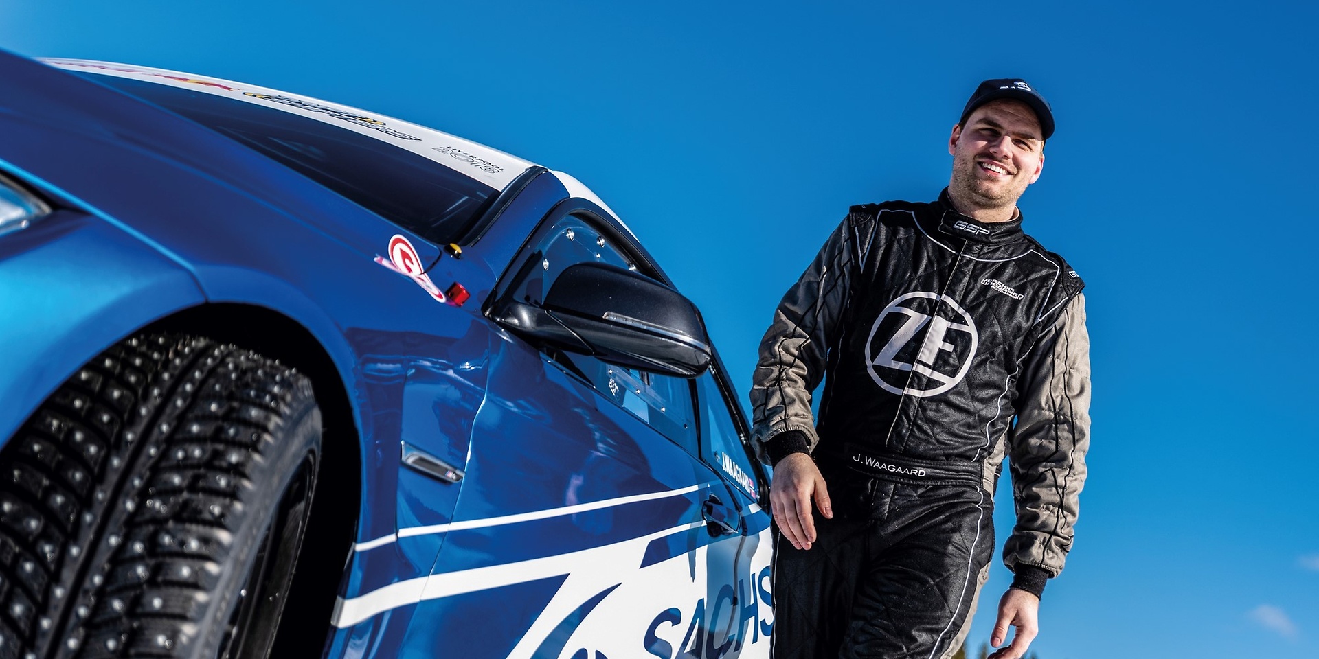 Joachim Waagaard next to a racing car